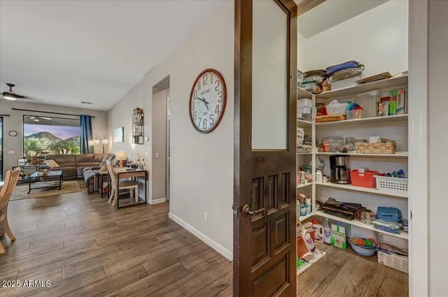 a view of a workspace with furniture and wooden floor