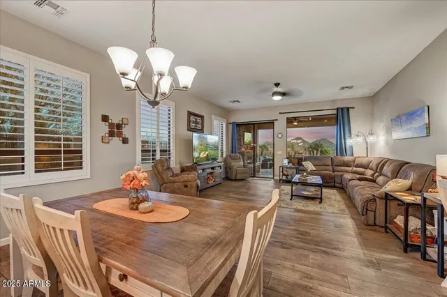 a view of a hallway with a couch and chandelier