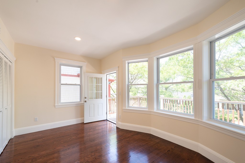 180 Magazine Street, Unit 2 Cambridge, MA 02139 - Photo 13 of 20 a view of an empty room with wooden floor and a window