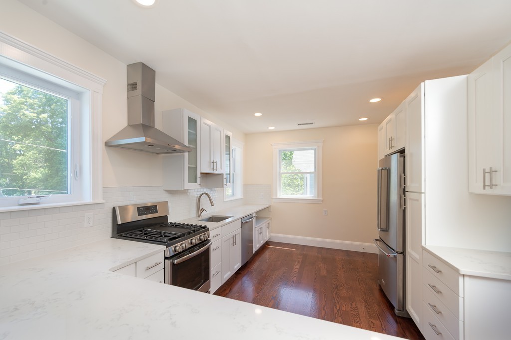 180 Magazine Street, Unit 2 Cambridge, MA 02139 - Photo 3 of 20 a kitchen with stainless steel appliances granite countertop a sink stove and refrigerator