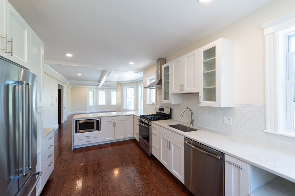180 Magazine Street, Unit 2 Cambridge, MA 02139 - Photo 4 of 20 a kitchen with a sink stove and refrigerator