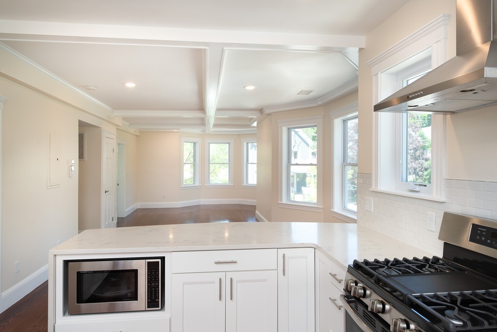 180 Magazine Street, Unit 2 Cambridge, MA 02139 - Photo 5 of 20 a kitchen with a stove and white cabinets