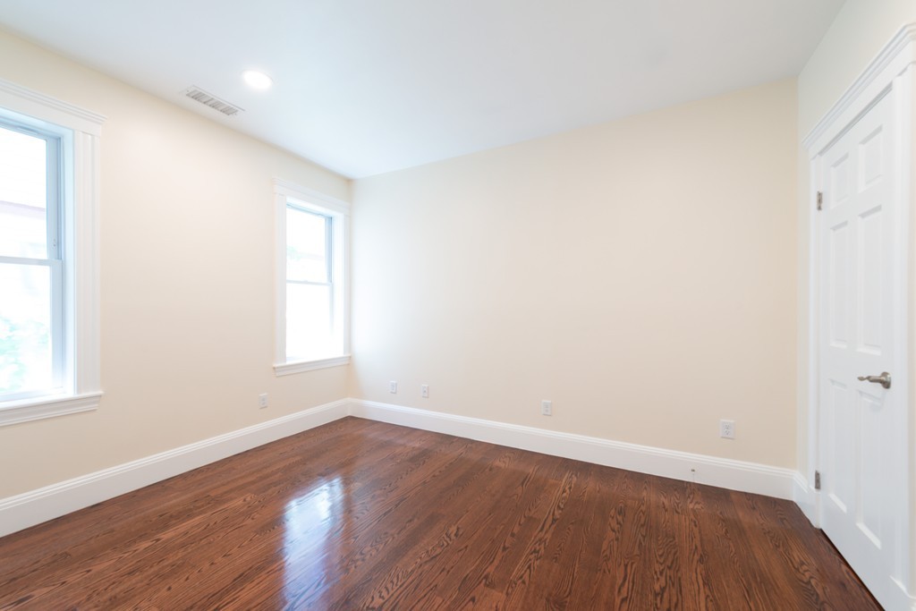 180 Magazine Street, Unit 2 Cambridge, MA 02139 - Photo 7 of 20 an empty room with wooden floor and windows
