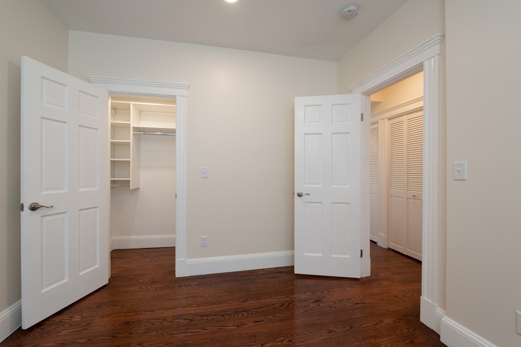 180 Magazine Street, Unit 2 Cambridge, MA 02139 - Photo 8 of 20 an empty room with wooden floor and windows