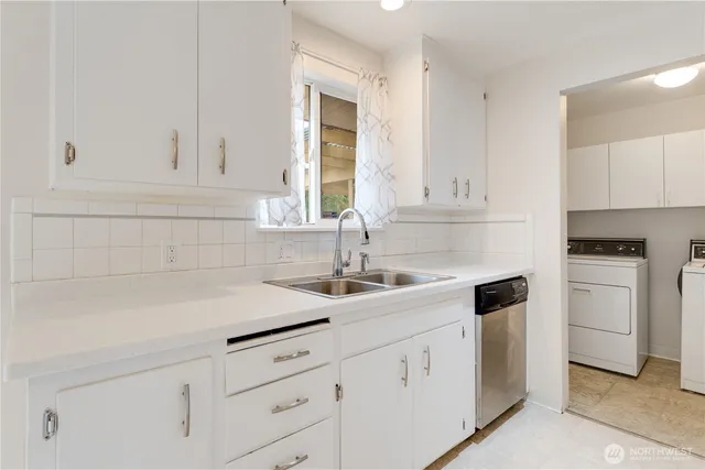 a kitchen with white cabinets and a sink