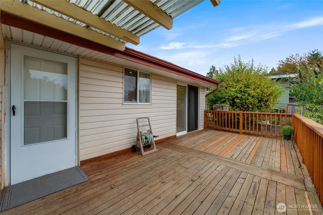 a balcony with wooden floor table and chair