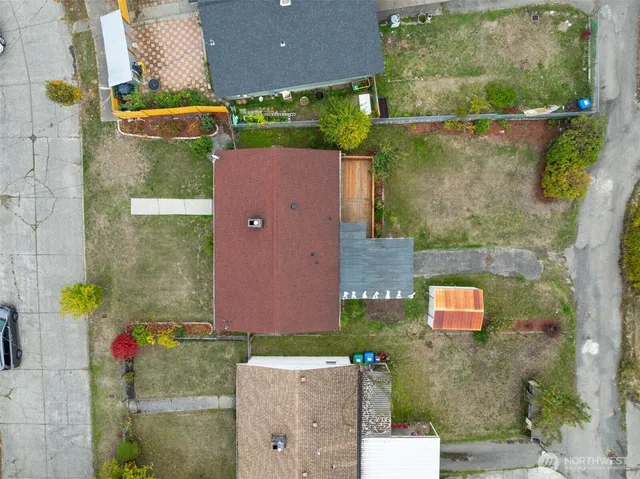an aerial view of residential houses with outdoor space and street view