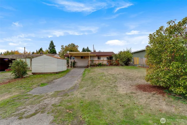 a view of a house with a yard and sitting area
