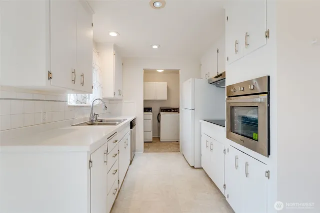 a kitchen with granite countertop a sink and cabinets