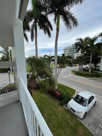 a balcony with outdoor seating and plants