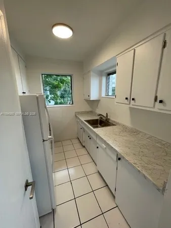 a kitchen with stainless steel appliances a sink stove and cabinets