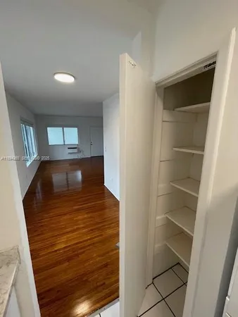 a view of hallway with wooden floor