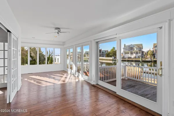 a view of a balcony with wooden floor and fence