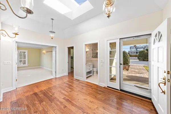 an empty room with windows and fireplace