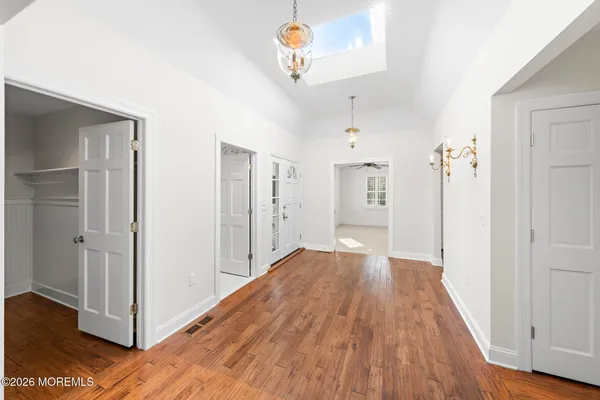a view of empty room with wooden floor and fireplace
