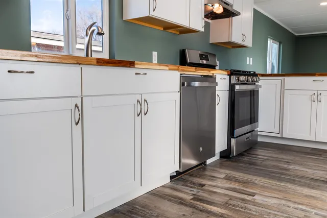 a kitchen with stainless steel appliances a refrigerator and a stove