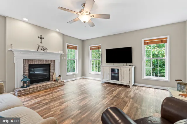 a living room with furniture fireplace and flat screen tv