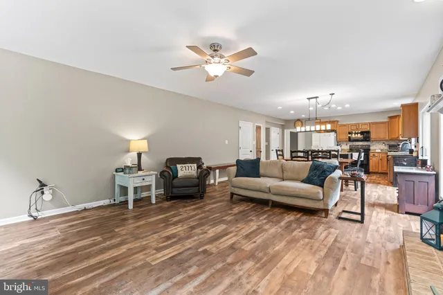 a living room with furniture and view of kitchen