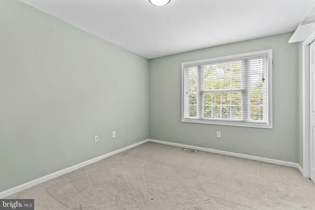 an empty room with closet area