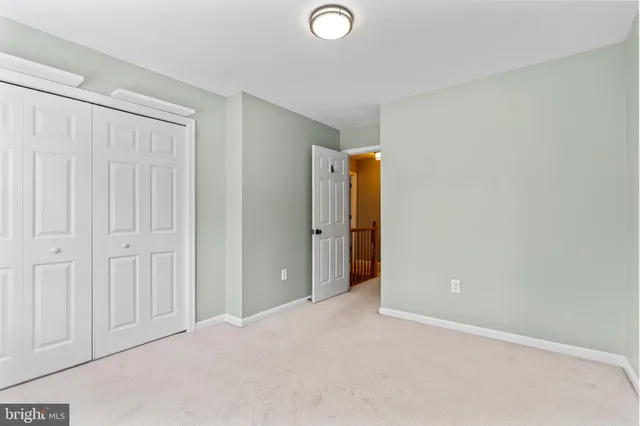 a bathroom with a granite countertop sink a toilet and a mirror