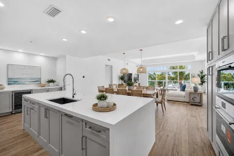 a kitchen with sink refrigerator and stove
