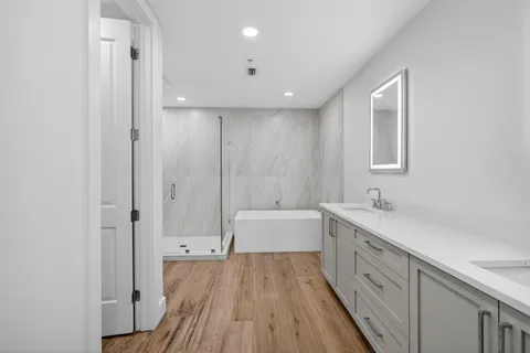 a bathroom with 2 sink tub and a mirror