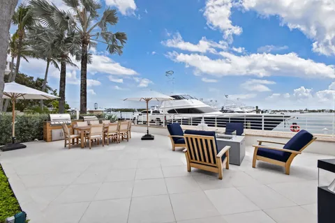 a view of roof deck with a barbeque and wooden stairs