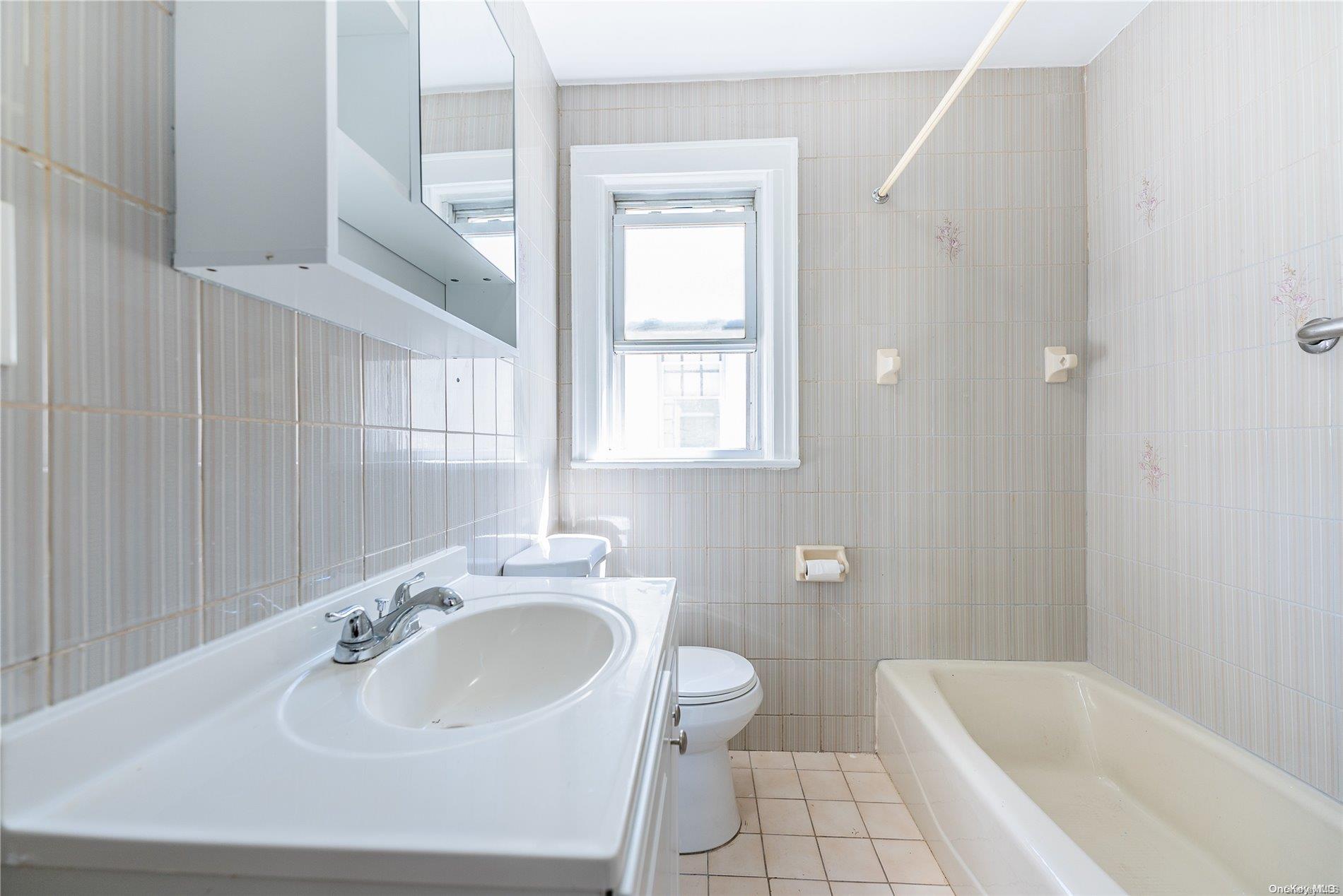55-15 96th Street Queens, NY 11368 - Photo 21 of 31 a bathroom with a sink and a bathtub