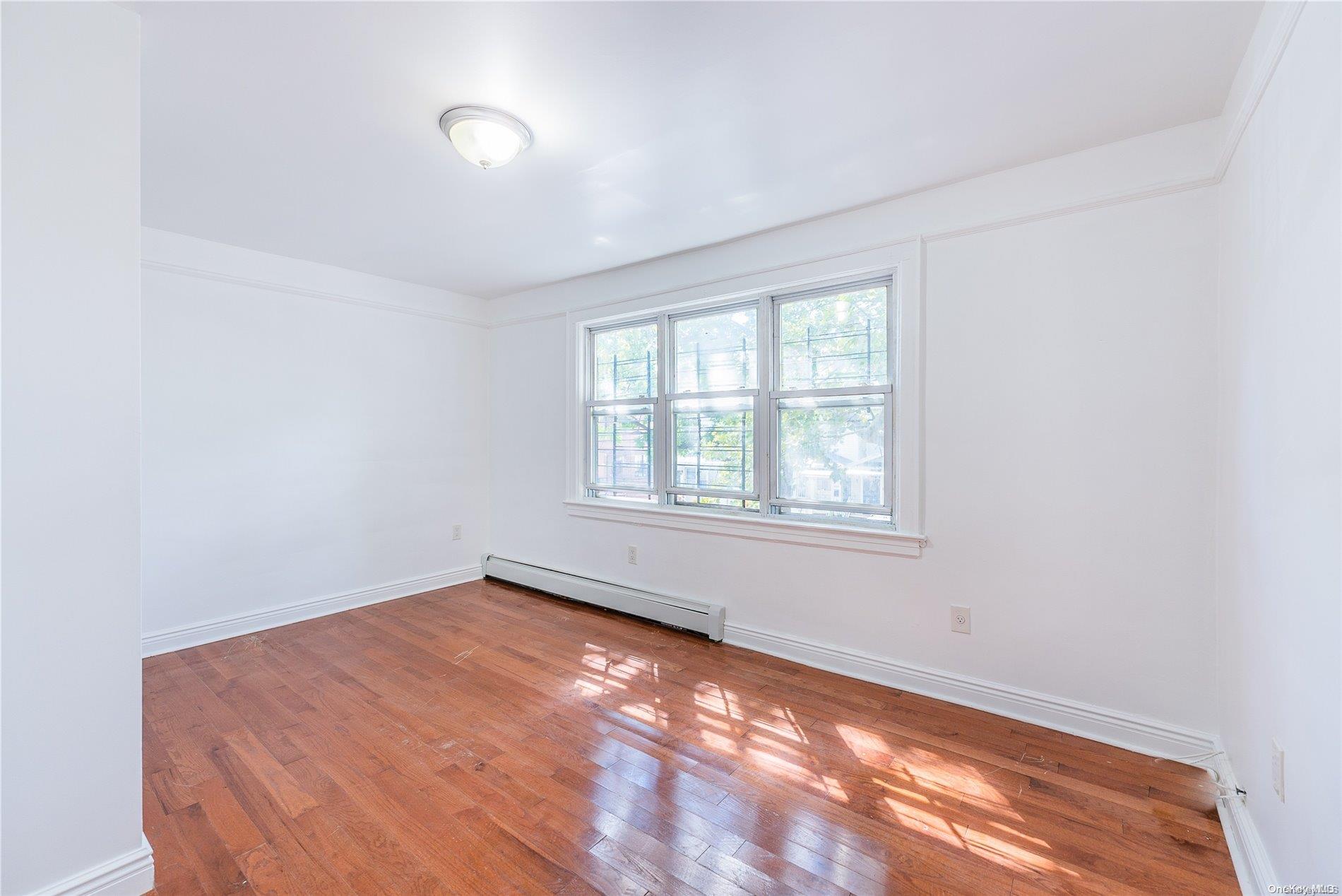 55-15 96th Street Queens, NY 11368 - Photo 22 of 31 an empty room with windows