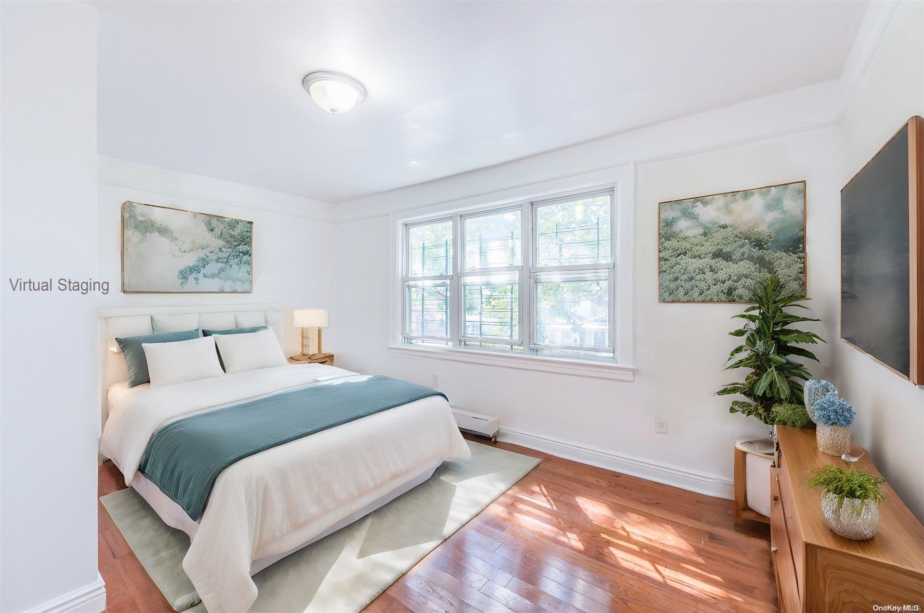 55-15 96th Street Queens, NY 11368 - Photo 24 of 31 a spacious bedroom with a bed and a potted plant