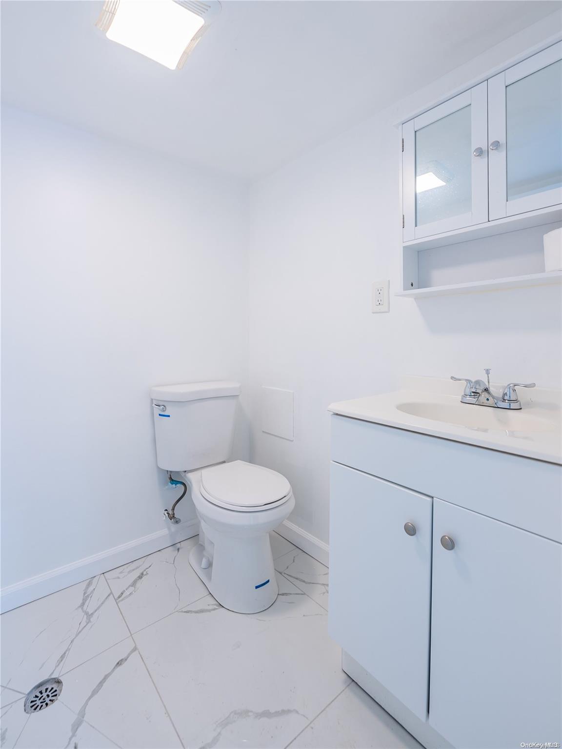 55-15 96th Street Queens, NY 11368 - Photo 26 of 31 a white toilet sitting next to a bathroom sink