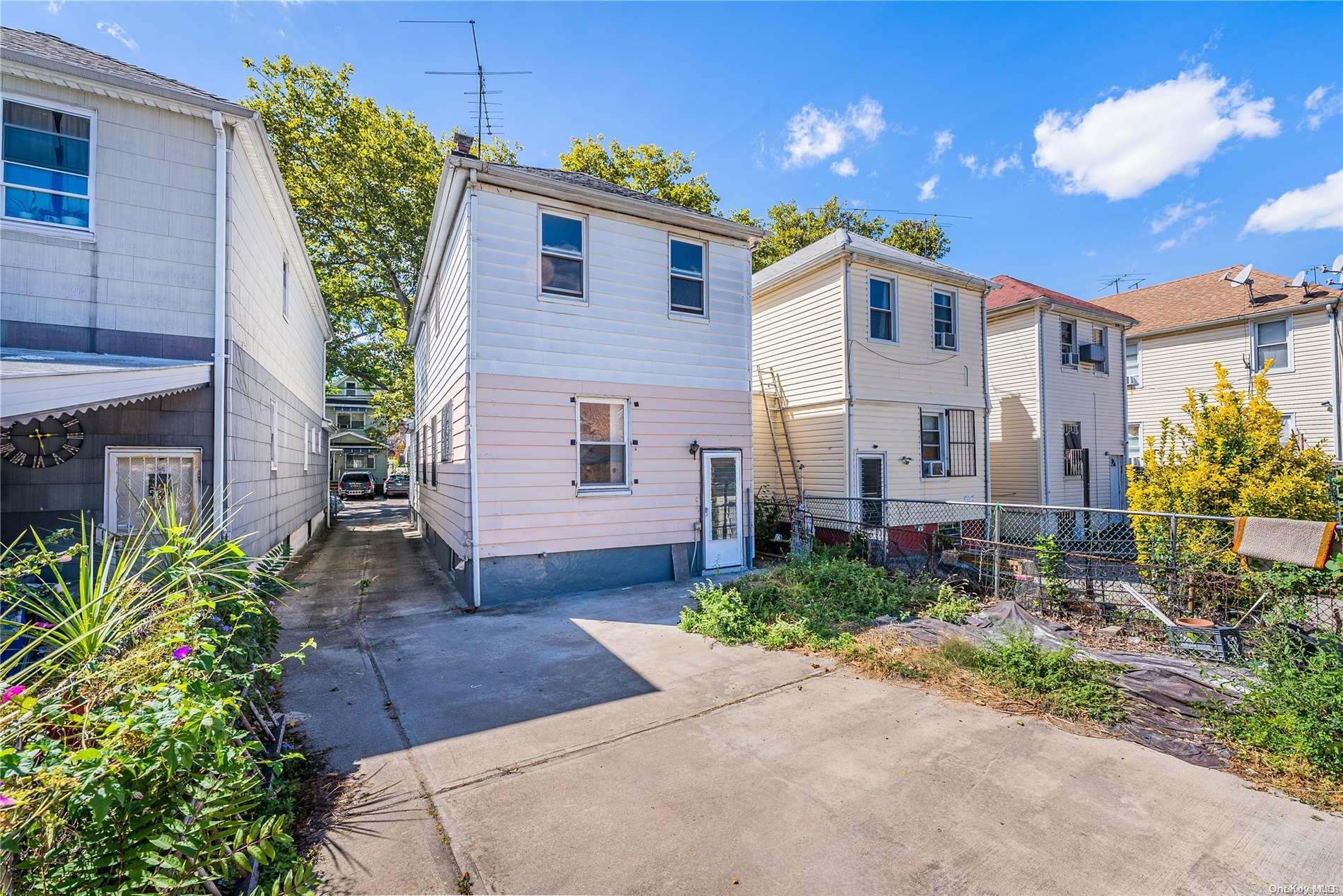 55-15 96th Street Queens, NY 11368 - Photo 30 of 31 a front view of a house with garden