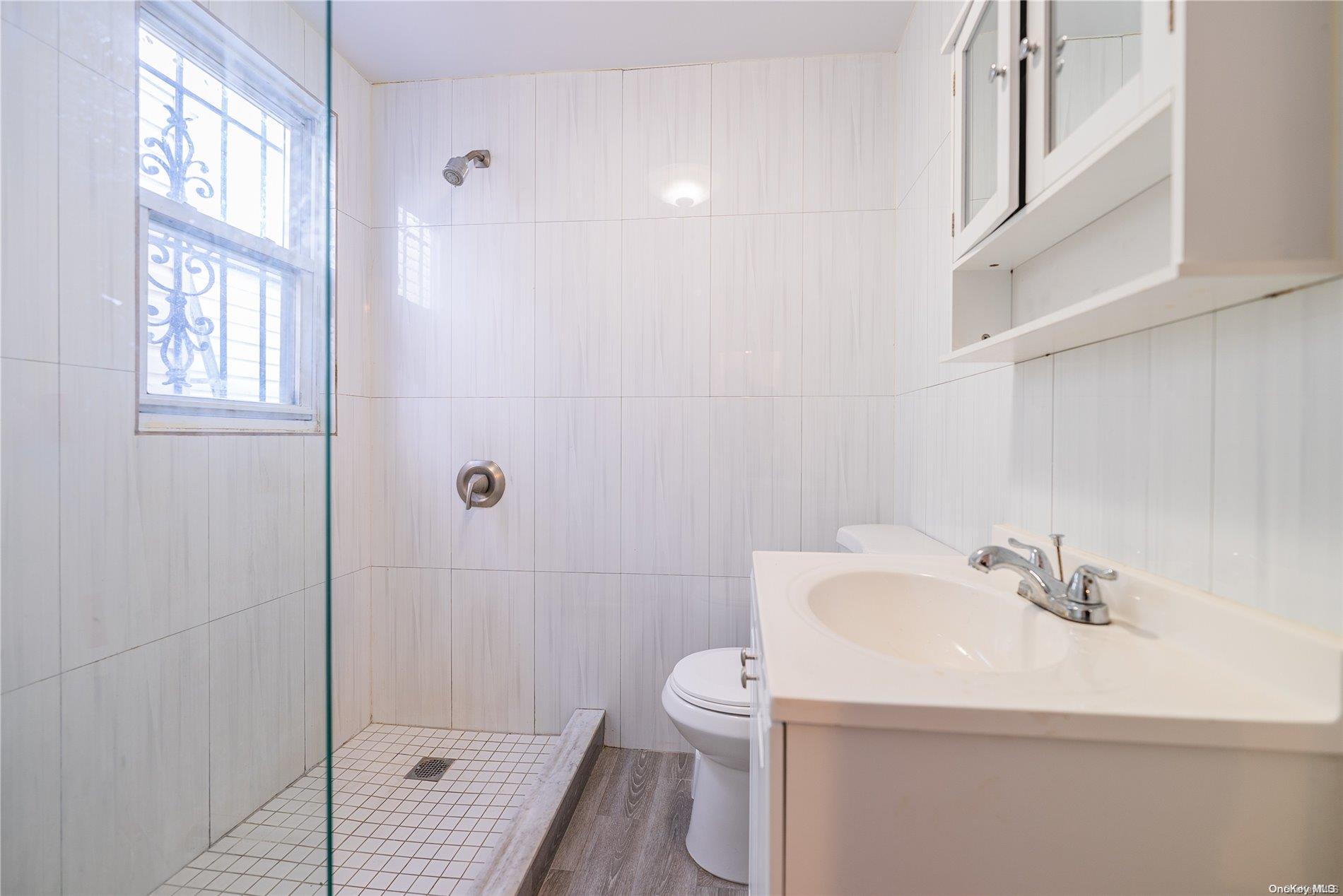 55-15 96th Street Queens, NY 11368 - Photo 10 of 31 a bathroom with a sink a toilet and shower