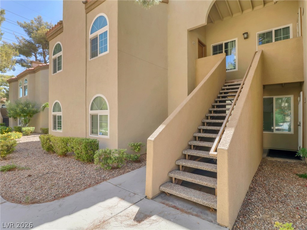 3145 East Flamingo Road, Unit 2129 Las Vegas, NV 89121 - Photo 3 of 43 Discover a welcoming entryway with an exterior staircase leading to upper-level residences.