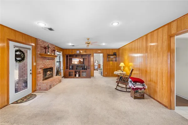 a view of a big room with furniture fire place and windows