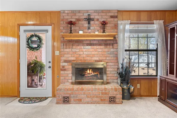 a living room with a fireplace and windows