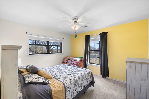 a bedroom with a bed a dresser and book shelf