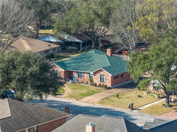 an aerial view of a houses with yard