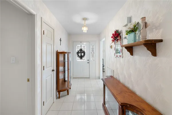 a hallway with beautiful frames and flower vase