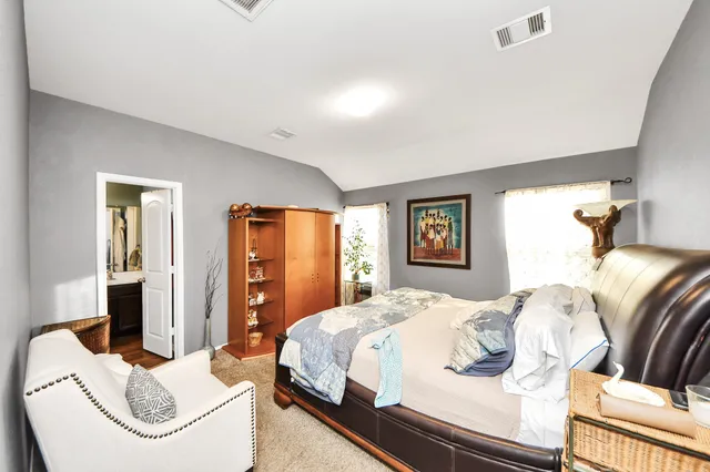 a bedroom with a bed table and a couch