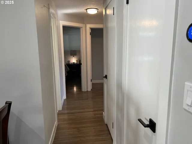 a view of a hallway with wooden floor
