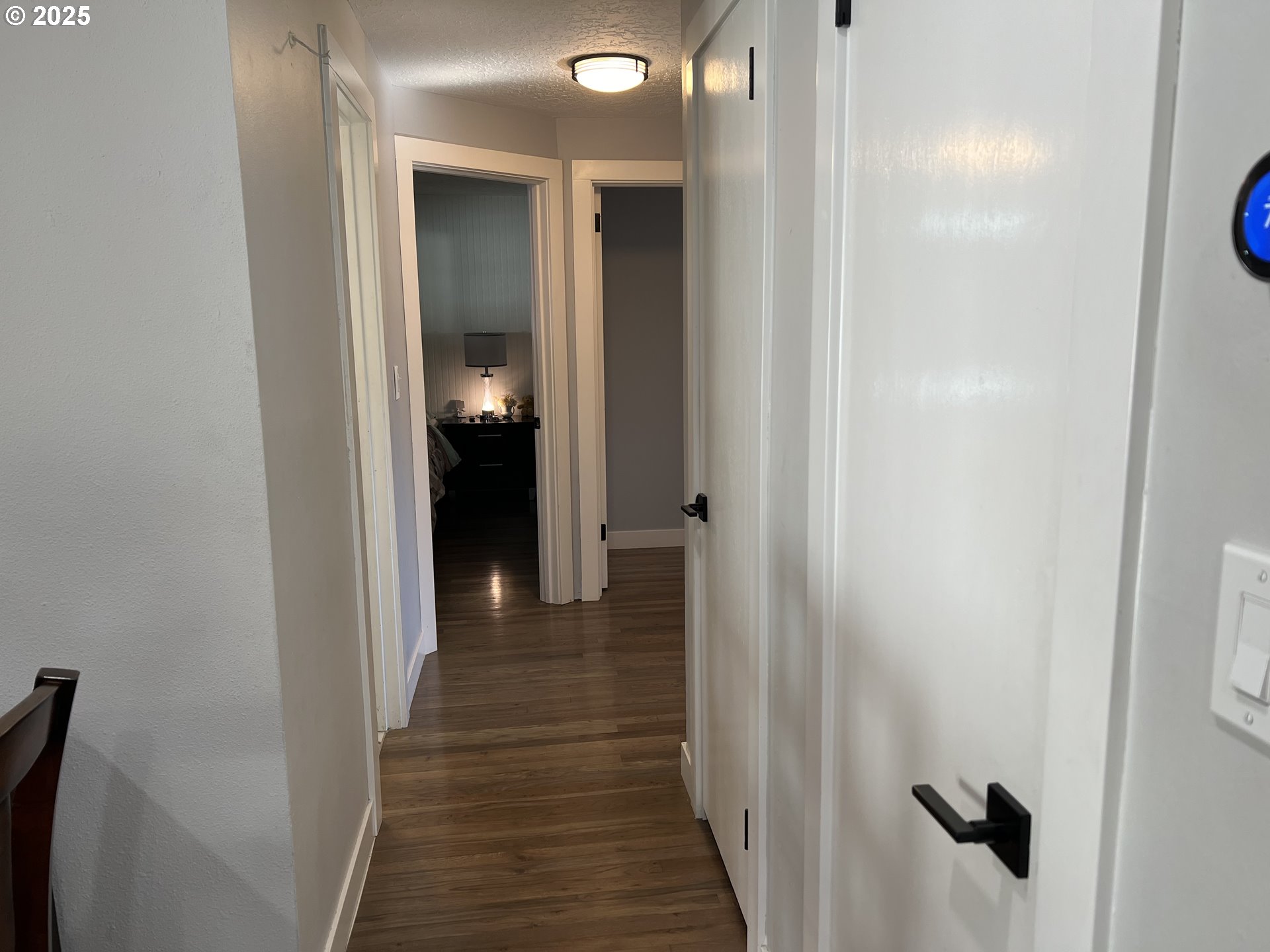 17519 Southeast Tibbetts Street Portland, OR 97236 - Photo 14 of 32 a view of a hallway with wooden floor