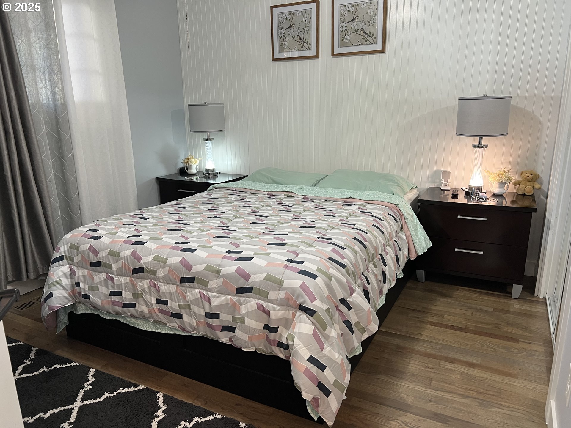 17519 Southeast Tibbetts Street Portland, OR 97236 - Photo 18 of 32 a bedroom with a bed and a lamp