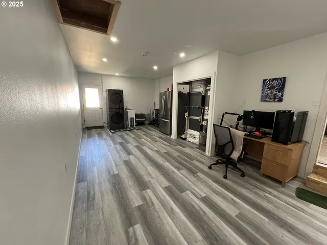 a view of a room with wooden floor and windows