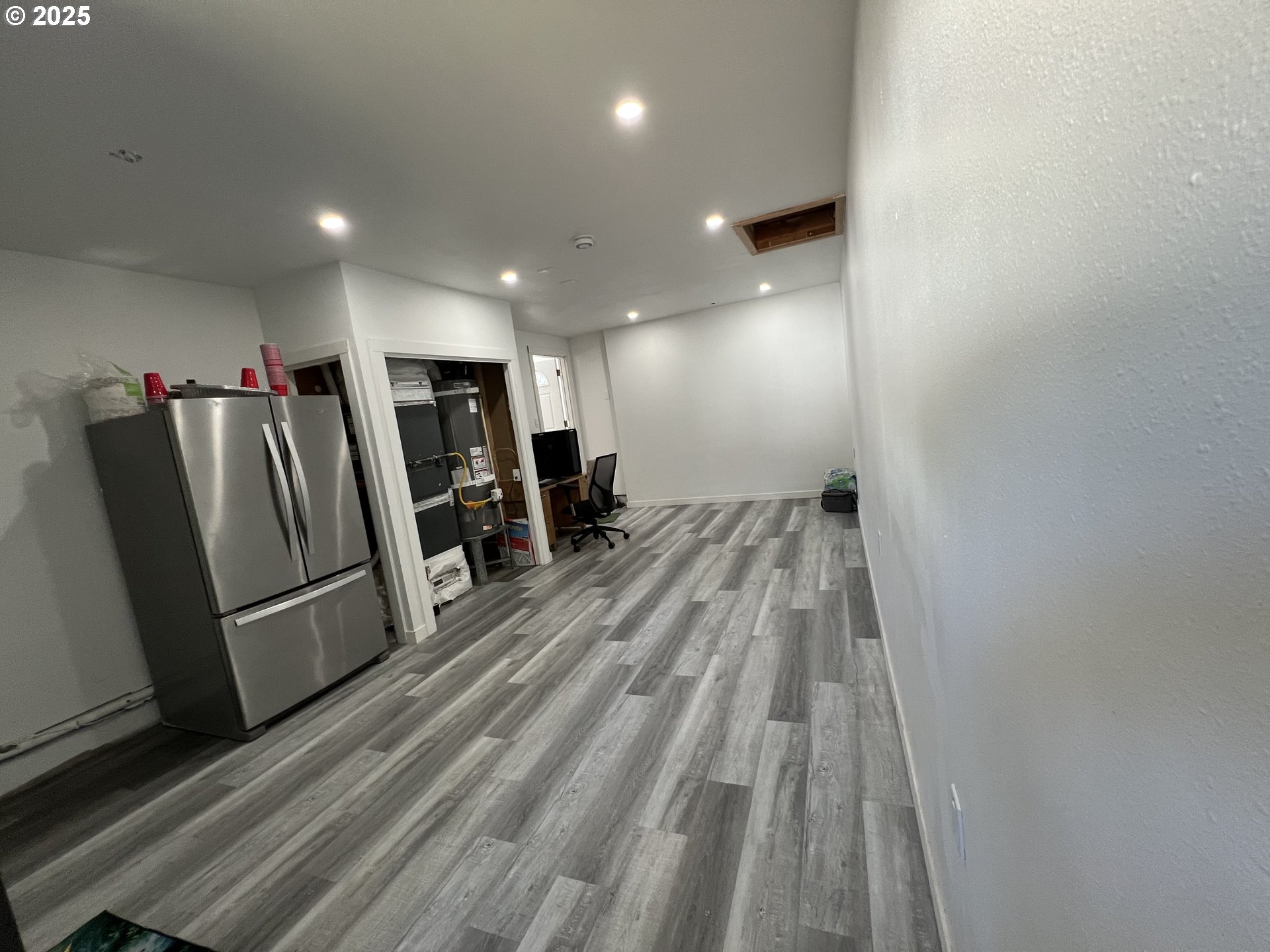 17519 Southeast Tibbetts Street Portland, OR 97236 - Photo 27 of 32 a view of a room with wooden floor and windows