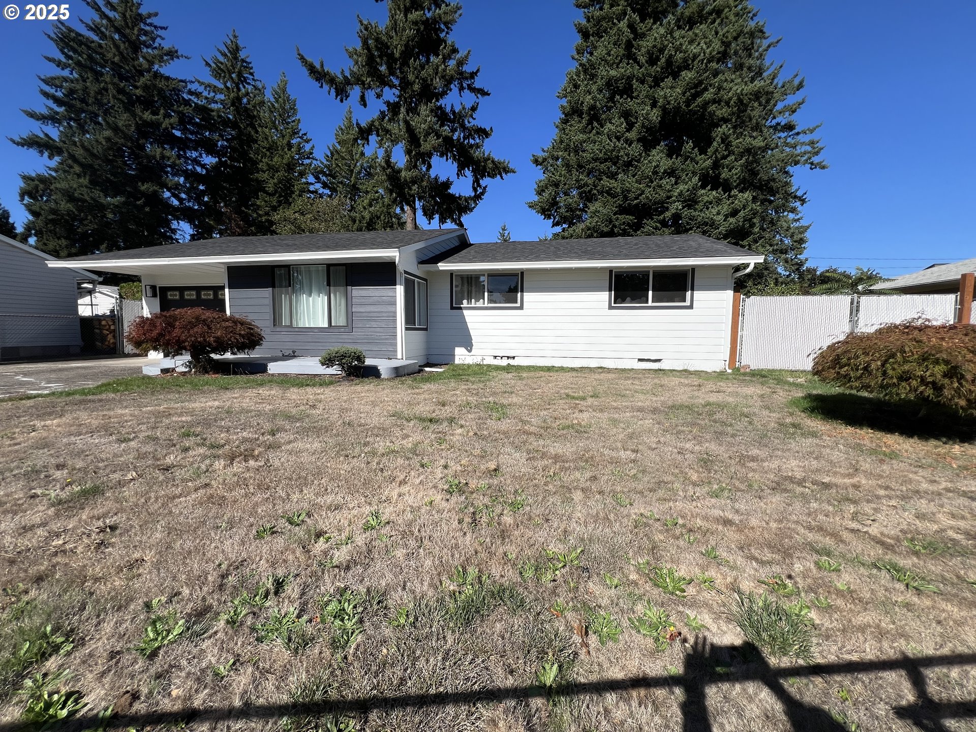17519 Southeast Tibbetts Street Portland, OR 97236 - Photo 4 of 32 a house that has a tree in front of it