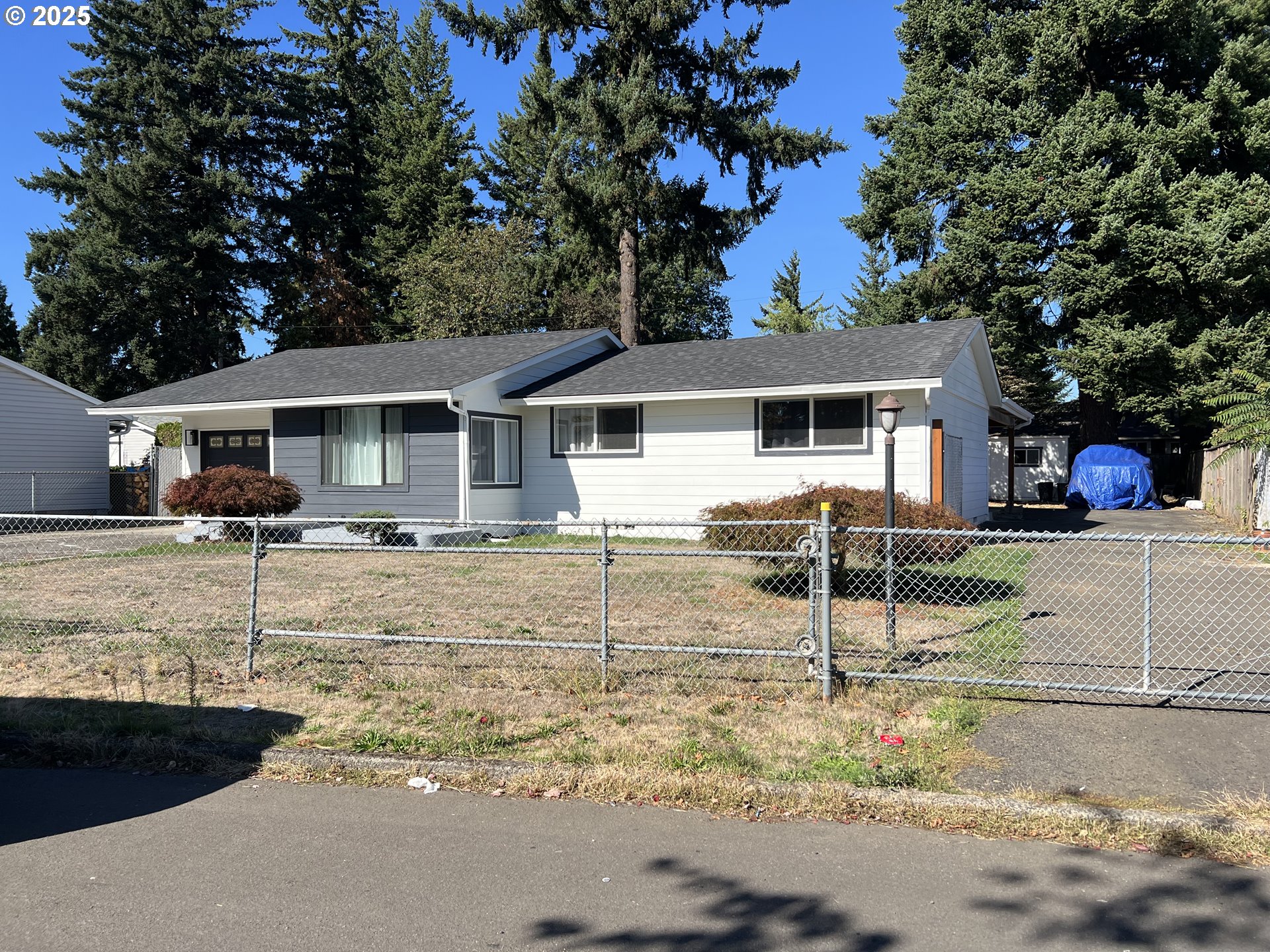 17519 Southeast Tibbetts Street Portland, OR 97236 - Photo 5 of 32 a view of a white house with a yard