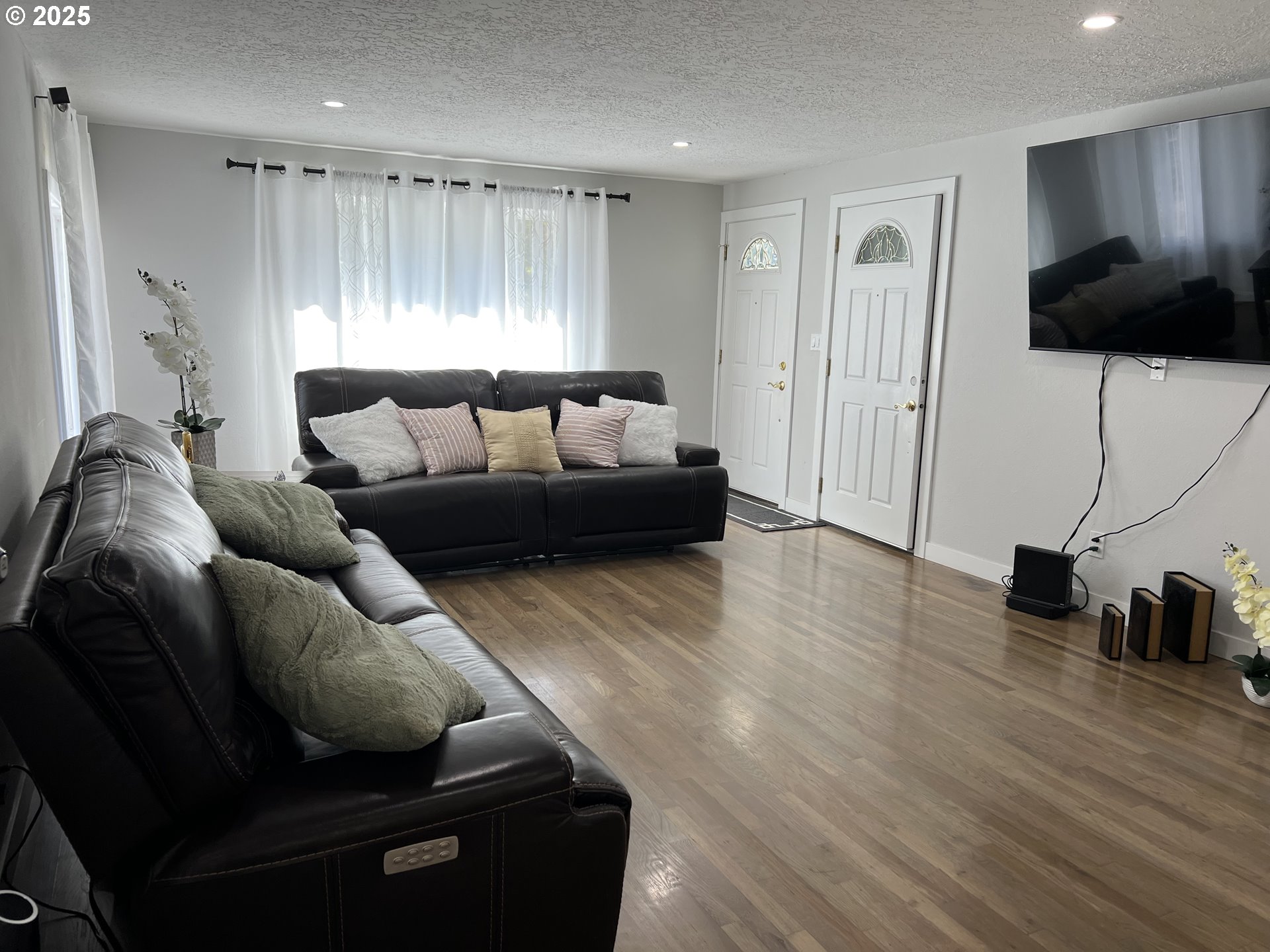 17519 Southeast Tibbetts Street Portland, OR 97236 - Photo 8 of 32 a living room with furniture and a flat screen tv