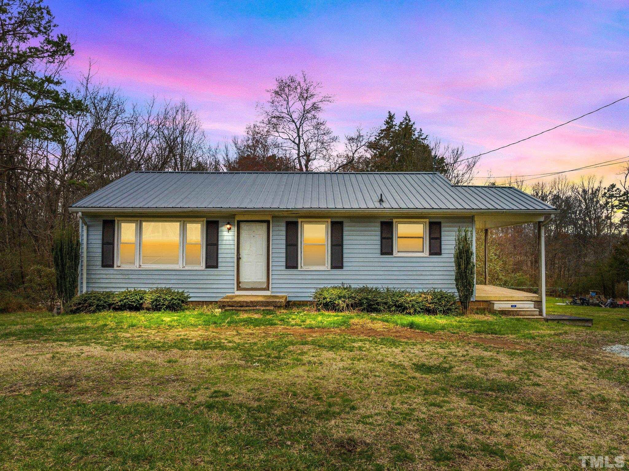 293 Cavel Chub Lake Road Roxboro, NC 27574 - Photo 1 of 15 a view of a house with a yard
