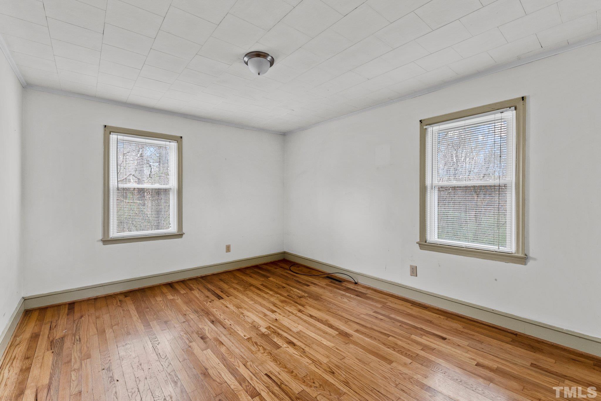 293 Cavel Chub Lake Road Roxboro, NC 27574 - Photo 12 of 15 a view of an empty room with wooden floor and a window